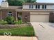 Brick front exterior featuring a two-car garage, well-kept lawn and tasteful landscaping at 1419 Dominion Dr, Zionsville, IN 46077