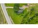 An aerial view highlights the home's proximity to roads, fields, and trees at 14855 E State Road 46, Columbus, IN 47203