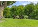 Relax and unwind in this park-like yard featuring plenty of shady trees at 14855 E State Road 46, Columbus, IN 47203