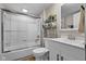 Bright bathroom featuring tub/shower combo, vanity, and decorative shelving at 14855 E State Road 46, Columbus, IN 47203