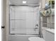 Bright bathroom featuring tub/shower combo, vanity, and decorative shelving at 14855 E State Road 46, Columbus, IN 47203