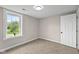 Bright bedroom with neutral walls, carpeted floors, and a large window at 14855 E State Road 46, Columbus, IN 47203