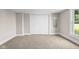 This bedroom features neutral carpeting and paint, plus ample closet space at 14855 E State Road 46, Columbus, IN 47203