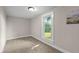 Neutral bedroom with carpeted floors, light walls, and sunny window at 14855 E State Road 46, Columbus, IN 47203