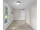 Neutral bedroom with carpeted floors, light walls and sunny window at 14855 E State Road 46, Columbus, IN 47203