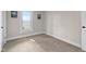 Neutral bedroom featuring carpeted floors and a sunny window at 14855 E State Road 46, Columbus, IN 47203