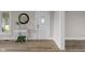 Bright entryway featuring new flooring, a white front door, and a charming side table with a round mirror at 14855 E State Road 46, Columbus, IN 47203