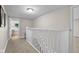 Hallway featuring white trim, neutral walls and carpet, and access to other rooms at 14855 E State Road 46, Columbus, IN 47203