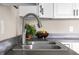 Close-up on stainless steel kitchen sink with neutral countertop at 14855 E State Road 46, Columbus, IN 47203