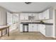 Bright kitchen featuring white cabinets, stainless appliances, and neutral counters at 14855 E State Road 46, Columbus, IN 47203