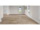 Another view of the spacious living room with new flooring, neutral paint, and great natural light at 14855 E State Road 46, Columbus, IN 47203