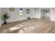 Bright living room showcasing new flooring, neutral paint, a white front door, and ample natural light at 14855 E State Road 46, Columbus, IN 47203