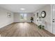 Spacious living room featuring new flooring, neutral paint, large windows, and stylish decor at 14855 E State Road 46, Columbus, IN 47203