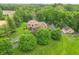 Stunning aerial view of a brick home on a lush green lawn, surrounded by mature trees at 1497 N 200 W, Greenfield, IN 46140