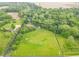 Aerial view of home and property outlined in blue showing the large lot size with lush trees at 1497 N 200 W, Greenfield, IN 46140