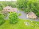 Expansive property featuring a brick home, two-car garage, and a serene gazebo nestled among lush trees at 1497 N 200 W, Greenfield, IN 46140