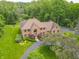 Aerial view of a brick home featuring well-maintained landscaping and a circular driveway at 1497 N 200 W, Greenfield, IN 46140