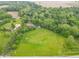Expansive aerial view of a large estate, featuring a beautiful home, extensive lawns, and surrounding mature trees at 1497 N 200 W, Greenfield, IN 46140