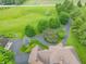 Aerial view of home with long driveway on a spacious lot with mature trees and a large grassy area at 1497 N 200 W, Greenfield, IN 46140