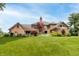 The brick house has a spacious backyard with a lawn, patio and outdoor furniture for relaxation and entertainment at 1497 N 200 W, Greenfield, IN 46140