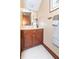 Bathroom vanity with warm wood tones, white countertop, and decorative mirror at 1497 N 200 W, Greenfield, IN 46140