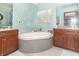 Luxurious bathroom with a soaking tub, granite countertops, and stylish fixtures at 1497 N 200 W, Greenfield, IN 46140