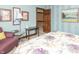 Bedroom featuring bright wall art and a cozy seating area in a naturally lit room at 1497 N 200 W, Greenfield, IN 46140