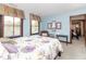 Bedroom with blinds-covered windows and adjacent sitting and work areas bathed in natural light at 1497 N 200 W, Greenfield, IN 46140