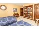 Cozy bedroom with built-in bookcase, desk, and two beds with blue patterned bedding at 1497 N 200 W, Greenfield, IN 46140