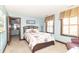 Bedroom with neutral carpet, windows with blinds, and a doorway to the bathroom at 1497 N 200 W, Greenfield, IN 46140