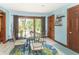 Bright breakfast nook with glass table, four chairs, and sliding glass doors to the backyard at 1497 N 200 W, Greenfield, IN 46140