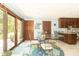 Bright breakfast nook with glass table, four chairs, and sliding glass doors to the backyard at 1497 N 200 W, Greenfield, IN 46140