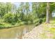 Scenic creek view surrounded by lush greenery and mature trees create a peaceful and serene setting at 1497 N 200 W, Greenfield, IN 46140