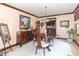 Cozy dining room featuring dark wood furniture and a view into the kitchen at 1497 N 200 W, Greenfield, IN 46140