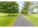 Long driveway lined with trees, providing a grand entrance to the property at 1497 N 200 W, Greenfield, IN 46140