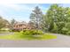 A lush yard surrounds this brick home with mature trees and landscaping creating a private and picturesque setting at 1497 N 200 W, Greenfield, IN 46140