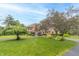 Well-manicured lawn and beautiful landscaping accentuate this home's curb appeal and charming brick facade at 1497 N 200 W, Greenfield, IN 46140