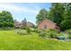 Charming home with landscaped gardens, creating a serene and inviting outdoor space at 1497 N 200 W, Greenfield, IN 46140