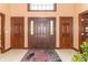 The foyer features tile flooring, a decorative rug, and multiple doors offering a grand and welcoming entrance at 1497 N 200 W, Greenfield, IN 46140