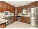 Updated kitchen featuring granite countertops, stainless steel appliances, and warm wooden cabinetry at 1497 N 200 W, Greenfield, IN 46140