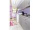Functional laundry room with washer, dryer, ample storage cabinets, and counter space at 1497 N 200 W, Greenfield, IN 46140