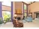 Spacious living room featuring tall windows, a brick fireplace, and comfortable furniture at 1497 N 200 W, Greenfield, IN 46140