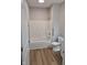 Bathroom featuring a shower and tub combo, new flooring, and a modern toilet at 1501 California St, Columbus, IN 47201