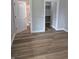 This bedroom features wood-look flooring and access to a walk-in closet and attached bathroom at 1501 California St, Columbus, IN 47201