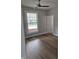 Serene bedroom with wood floors, a ceiling fan, and a large window offering natural light at 1501 California St, Columbus, IN 47201
