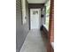 Welcoming entryway features a white front door and modern gray siding with brick accents at 1501 California St, Columbus, IN 47201