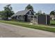 Charming home with gray siding, well-maintained lawn, shed, and inviting front porch at 1501 California St, Columbus, IN 47201