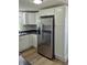 This kitchen features a stainless refrigerator, white cabinets and black countertops at 1501 California St, Columbus, IN 47201