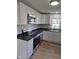 This kitchen has stainless appliances and modern black countertops and white cabinets at 1501 California St, Columbus, IN 47201