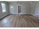 This living room has a ceiling fan and has wood-look flooring, with painted walls and trim at 1501 California St, Columbus, IN 47201